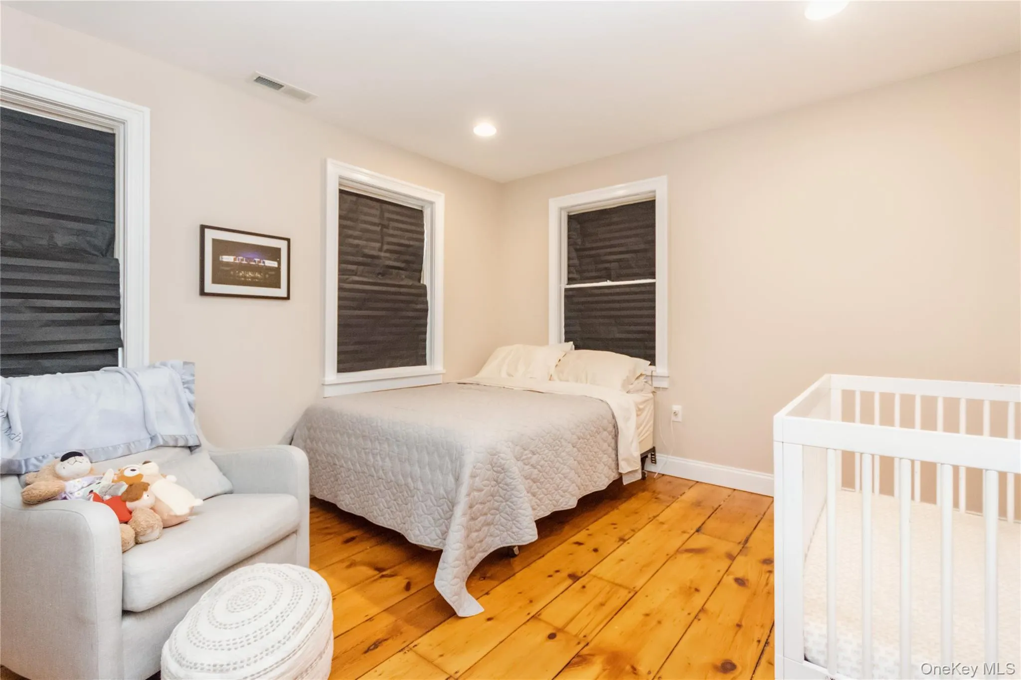Bedroom with light wood-style flooring and recessed lighting Bedroom with light wood-style flooring and recessed lighting