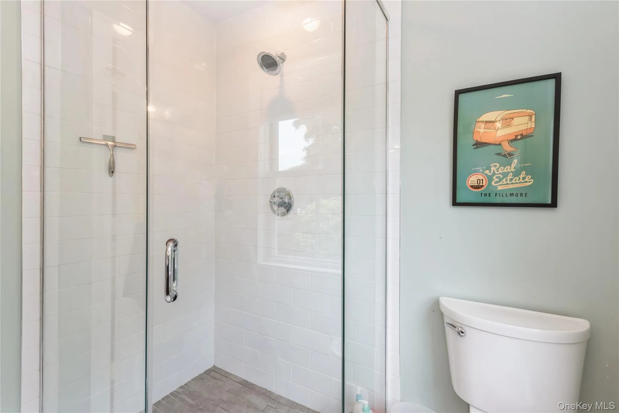 Bathroom featuring toilet and a shower stall Bathroom featuring toilet and a shower stall