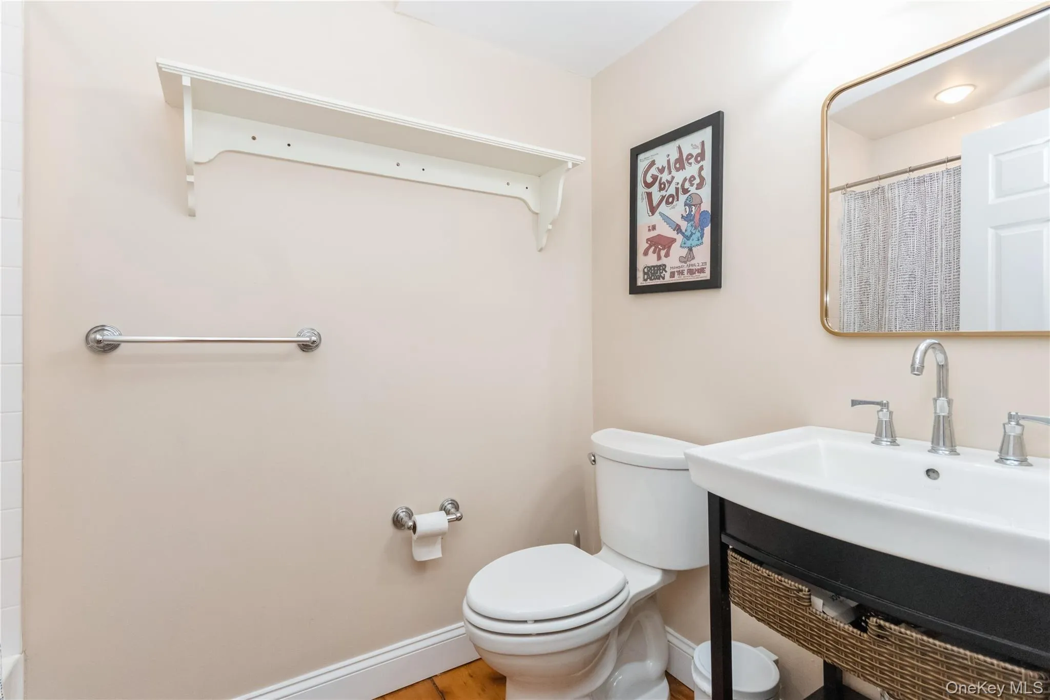 Full bathroom featuring vanity, wood finished floors, and curtained shower Full bathroom featuring vanity, wood finished floors, and curtained shower