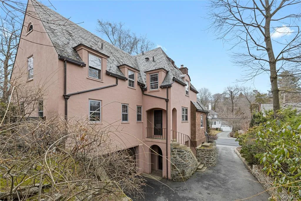 View of home's exterior with stairs, a chimney, and stucco siding View of home's exterior with stairs, a chimney, and stucco siding