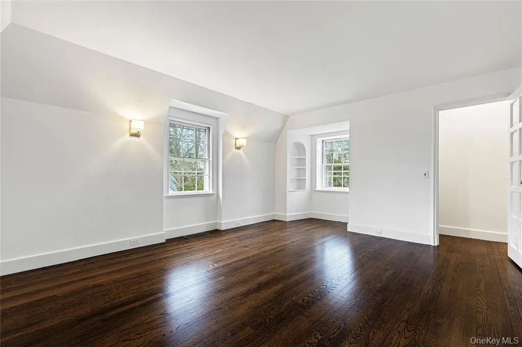 Second floor bedroom and dark wood-style floors, and built in features Second floor bedroom and dark wood-style floors, and built in features