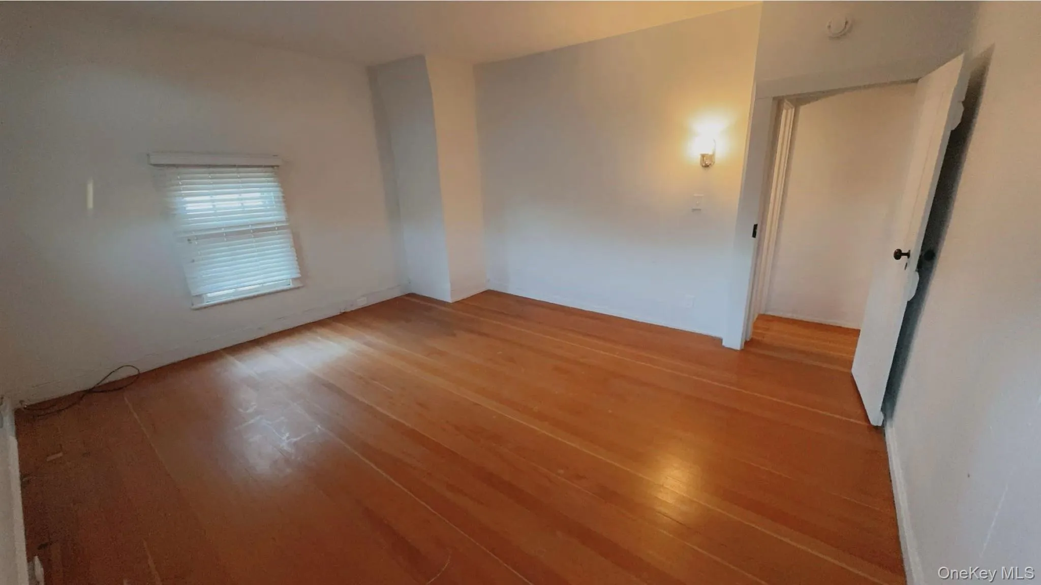 Empty room featuring wood-type flooring Empty room featuring wood-type flooring