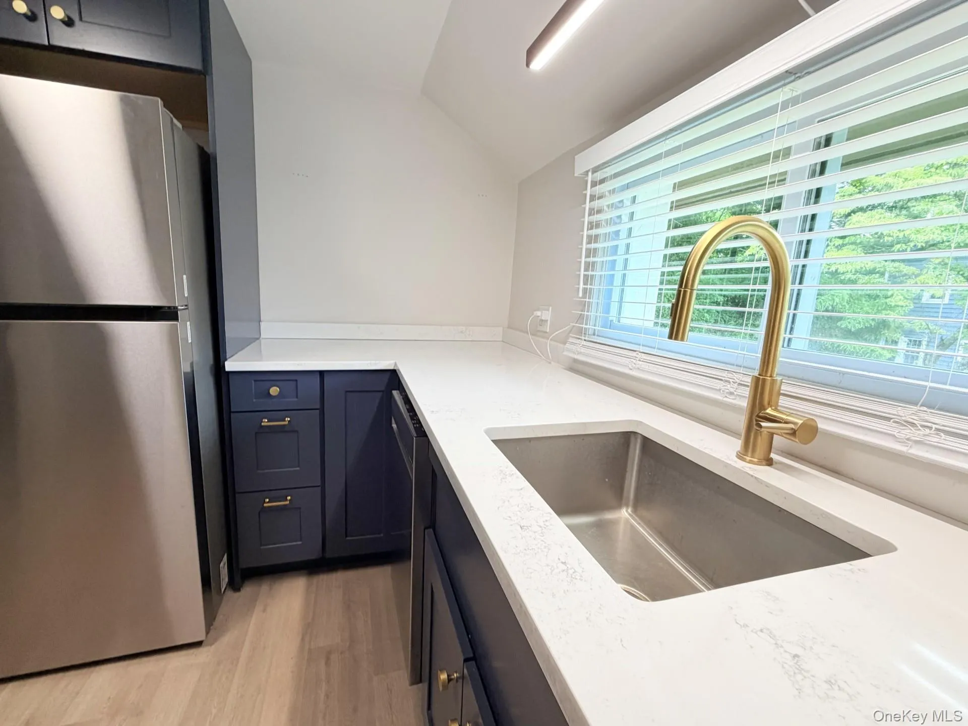 Gorgeous designer kitchen with quartz countertops , navy cabinets, gold harware and fixtures, stainless steel appliances. Gorgeous designer kitchen with quartz countertops , navy cabinets, gold harware and fixtures, stainless steel appliances.