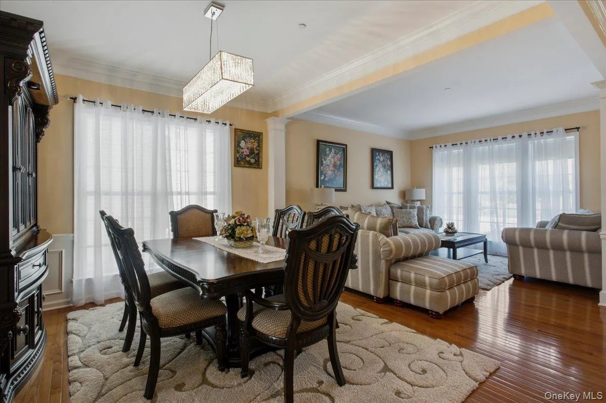 Spacious interior featuring wood-finish flooring and crown molding Spacious interior featuring wood-finish flooring and crown molding