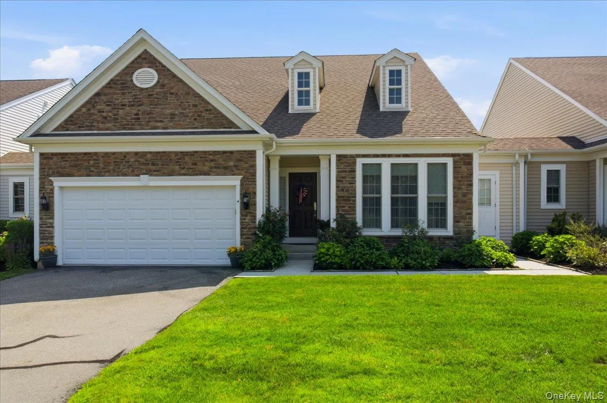 Stone veneer and siding exterior with a prominent front-facing gable Stone veneer and siding exterior with a prominent front-facing gable