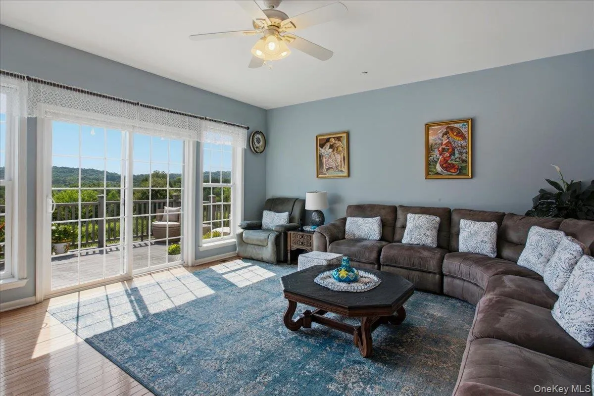 Living space featuring expansive sliding glass doors and side windows Living space featuring expansive sliding glass doors and side windows