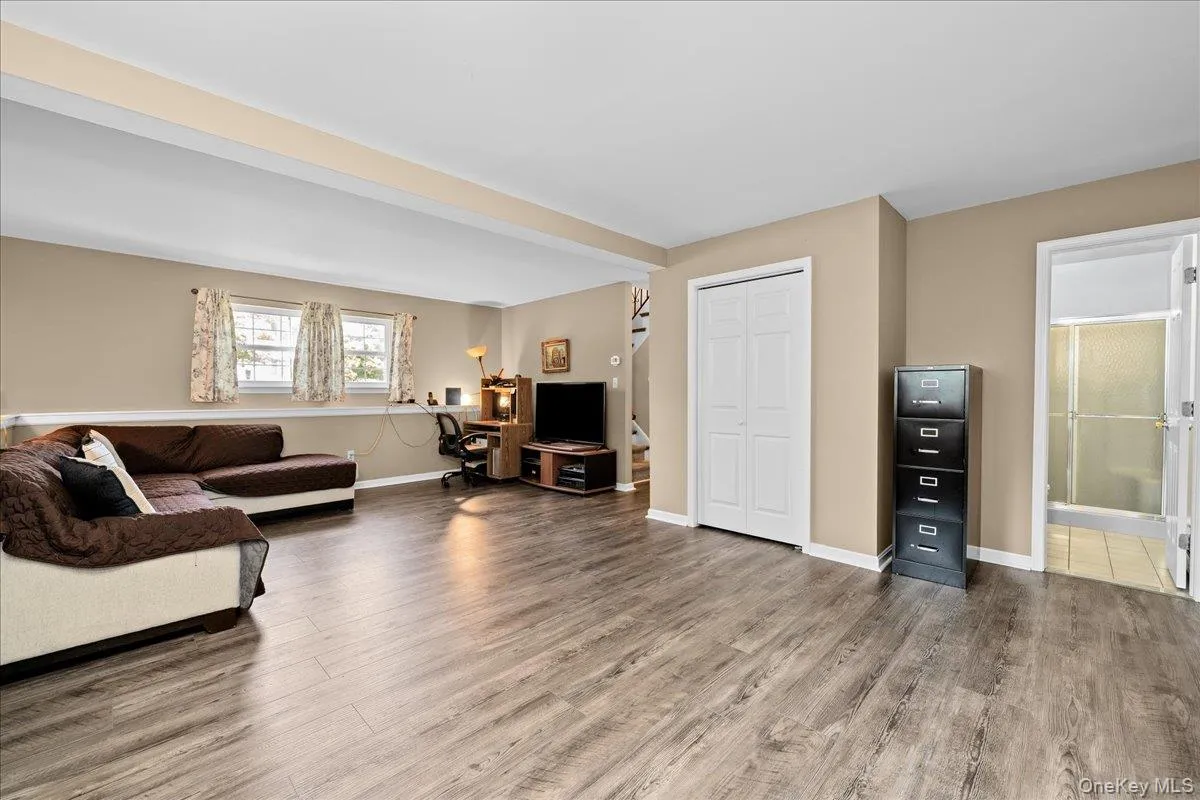Nice spacious room featuring wood-finish flooring, neutral-toned walls, and white trim Nice spacious room featuring wood-finish flooring, neutral-toned walls, and white trim