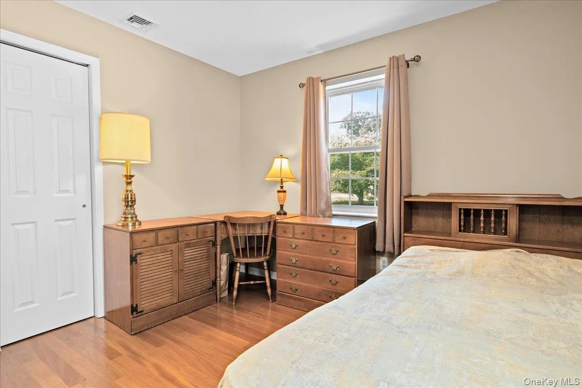 Bedroom 3 featuring hardwood flooring complemented by neutral wall tones Bedroom 3 featuring hardwood flooring complemented by neutral wall tones