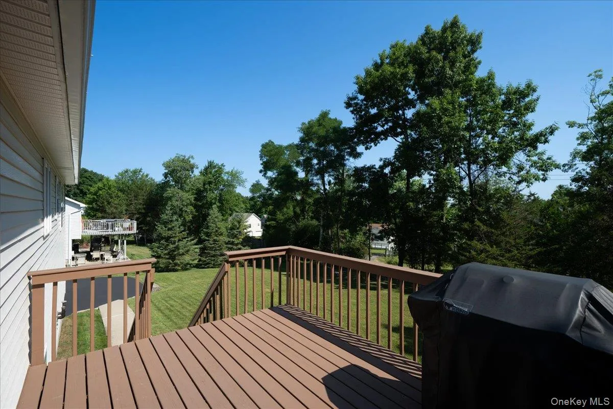 Spacious exterior deck with brown composite decking and matching railing. Spacious exterior deck with brown composite decking and matching railing.