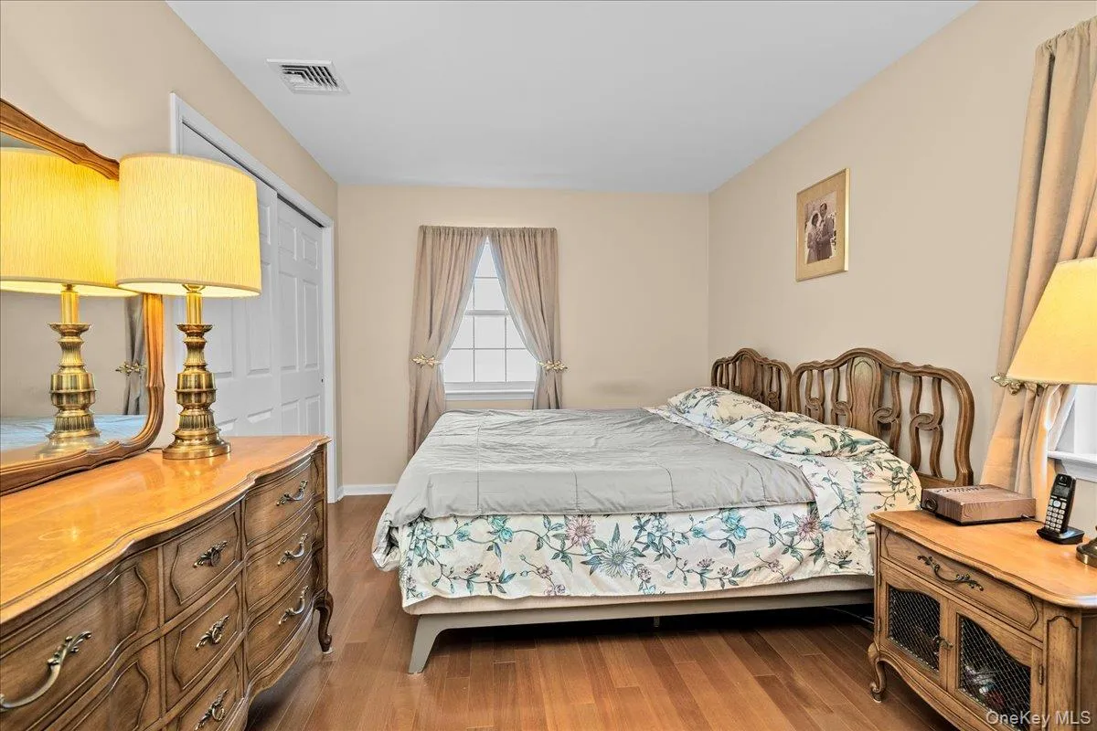 Bedroom 1 featuring light wood-finish flooring and neutral wall tones Bedroom 1 featuring light wood-finish flooring and neutral wall tones