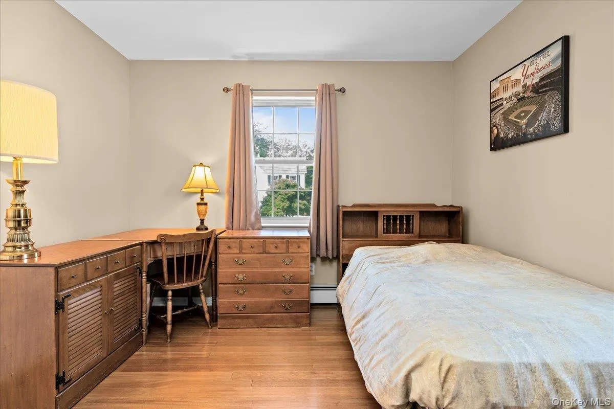 Bedroom 3 featuring hardwood flooring complemented by neutral wall tones Bedroom 3 featuring hardwood flooring complemented by neutral wall tones