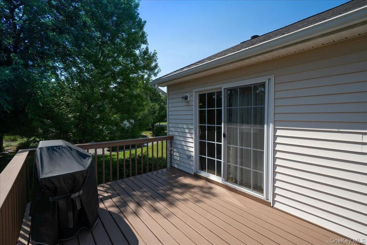 Composite outdoor deck with wood-finish flooring and railing Composite outdoor deck with wood-finish flooring and railing