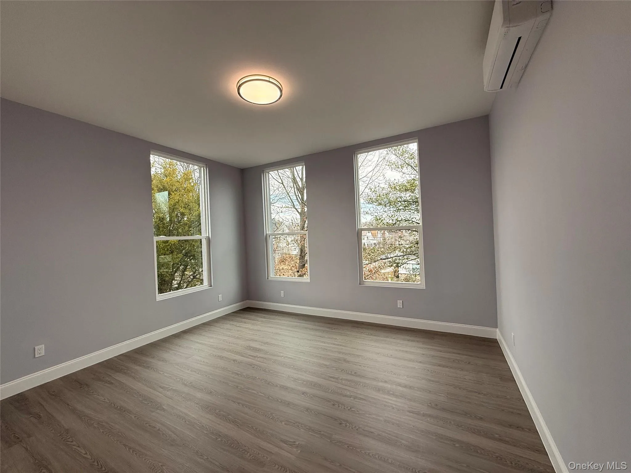 Bedroom #3 featuring dark wood-type flooring and plenty of natural light Bedroom #3 featuring dark wood-type flooring and plenty of natural light