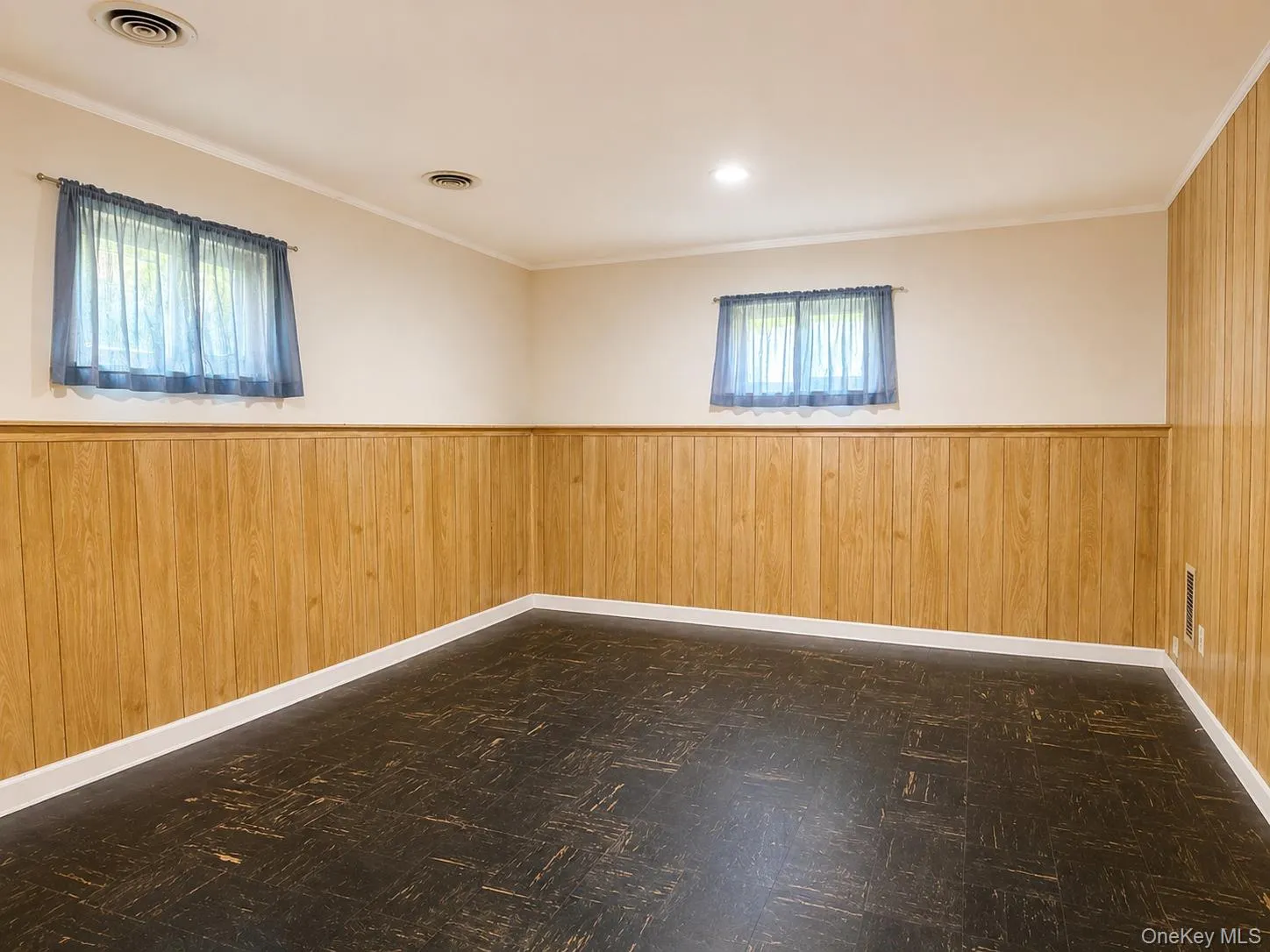 Recreation Room with wood-panel lower walls and light-colored upper walls Recreation Room with wood-panel lower walls and light-colored upper walls