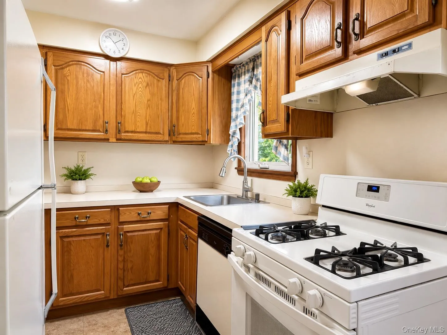 Kitchen featuring oak cabinetry and white countertops Kitchen featuring oak cabinetry and white countertops
