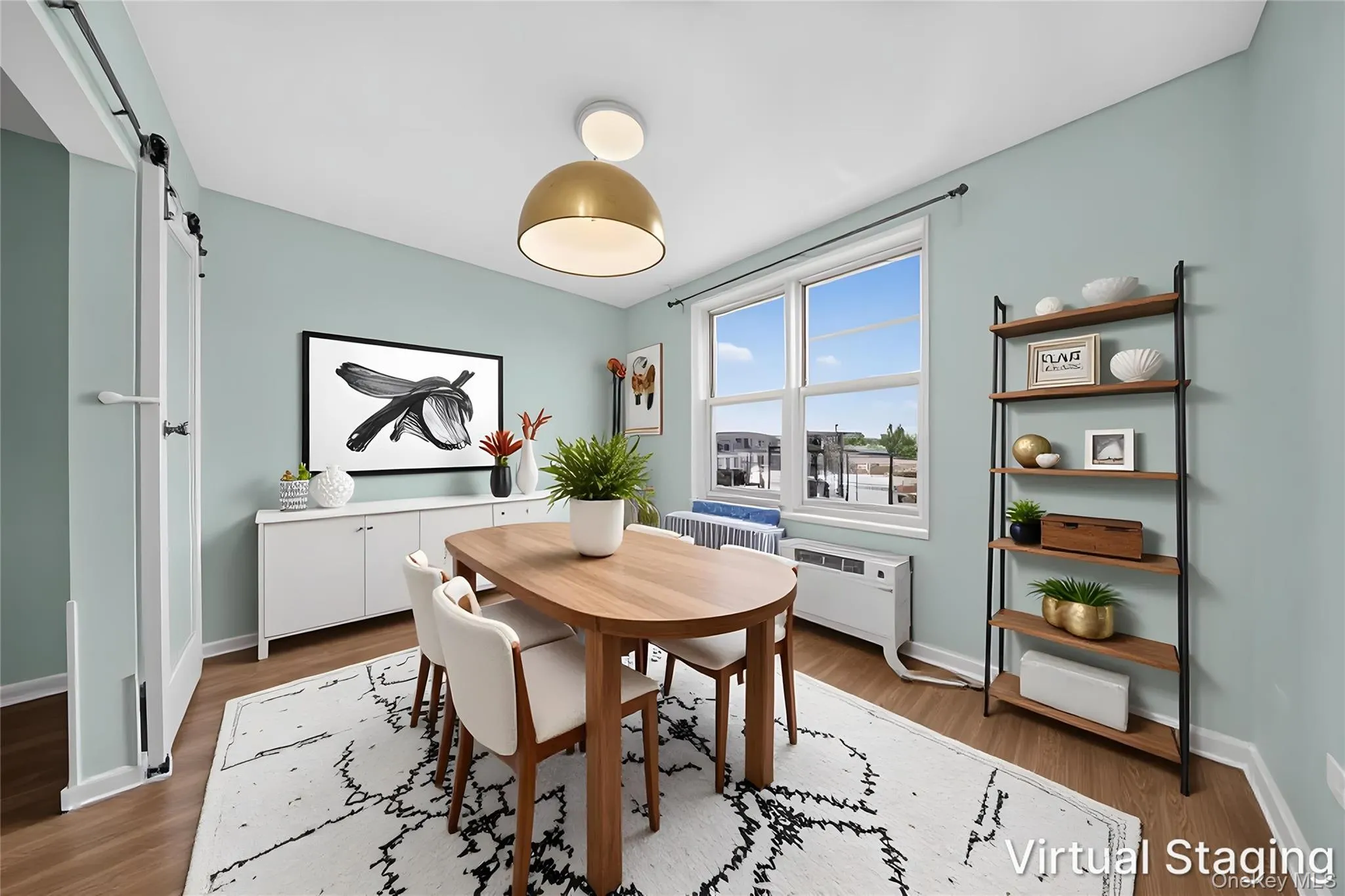 Spacious room featuring wood-finish flooring, a contemporary ceiling light fixture, and a large multi-pane window Spacious room featuring wood-finish flooring, a contemporary ceiling light fixture, and a large multi-pane window