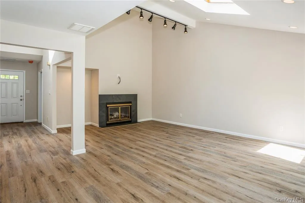 Living room with vaulted ceilings, sky light and fireplace Living room with vaulted ceilings, sky light and fireplace