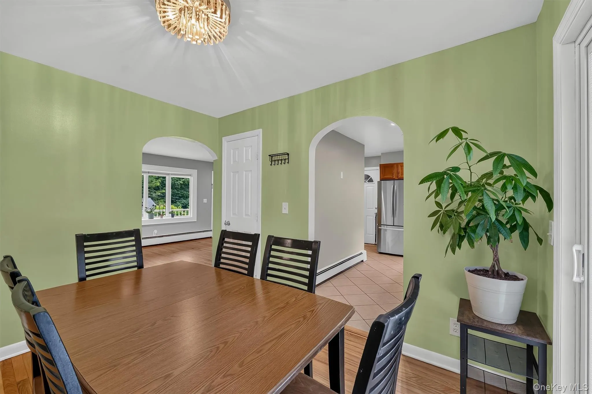 Bright dining room offers a comfortable setting for meals with an open view into the kitchen. Bright dining room offers a comfortable setting for meals with an open view into the kitchen.