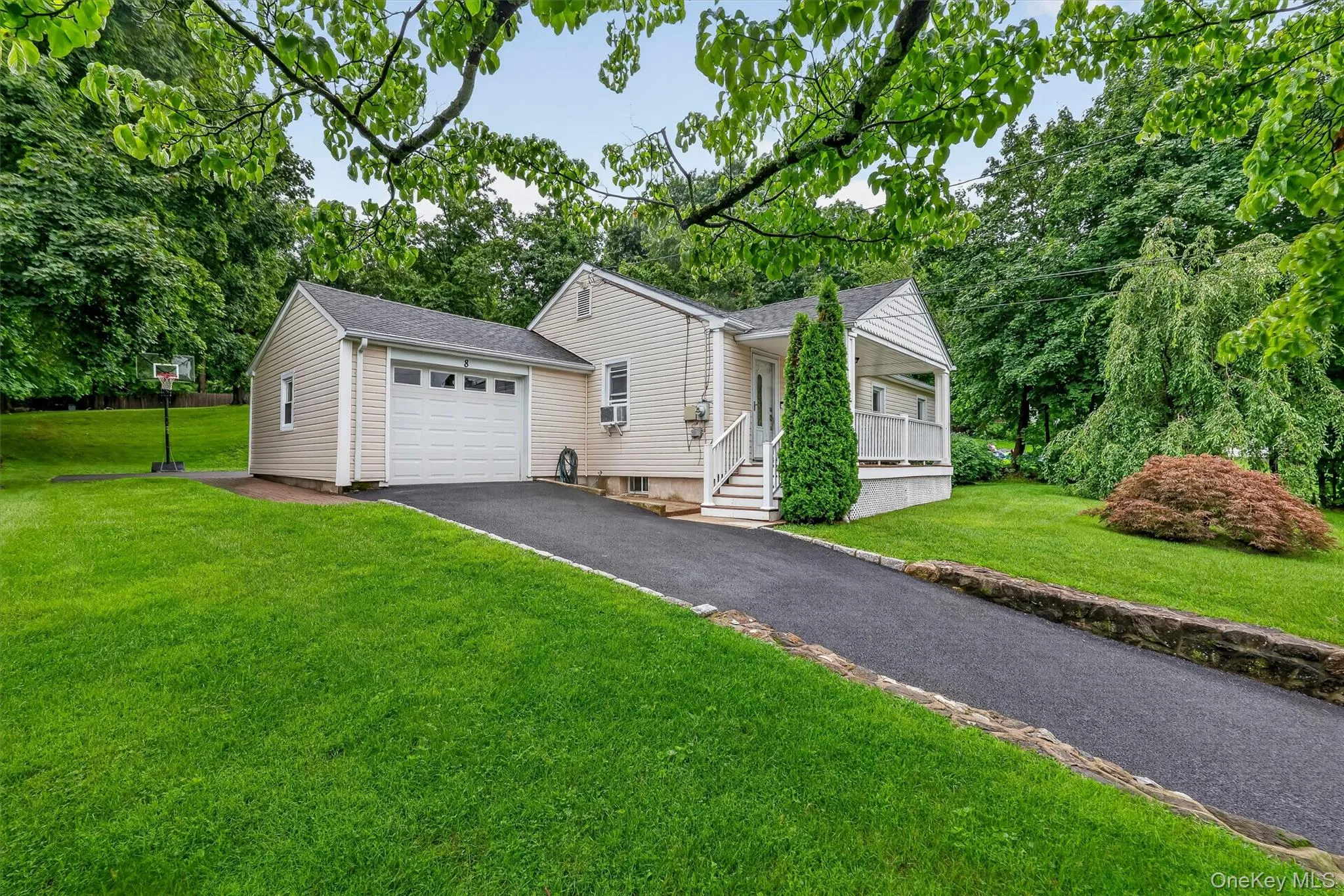 Charming curb appeal with welcoming front porch and newly paved driveway. Charming curb appeal with welcoming front porch and newly paved driveway.