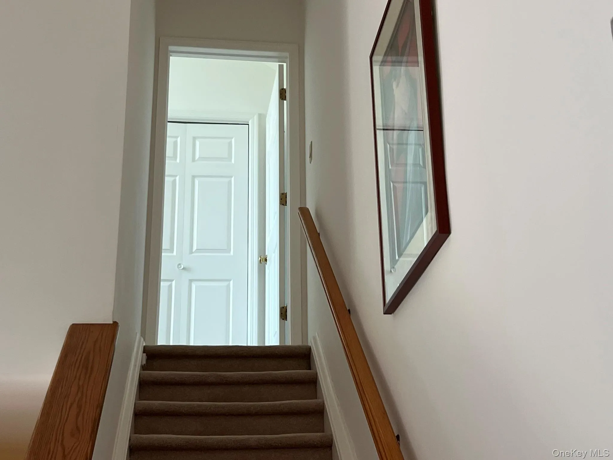Stairs up to the third level and second bedroom Stairs up to the third level and second bedroom