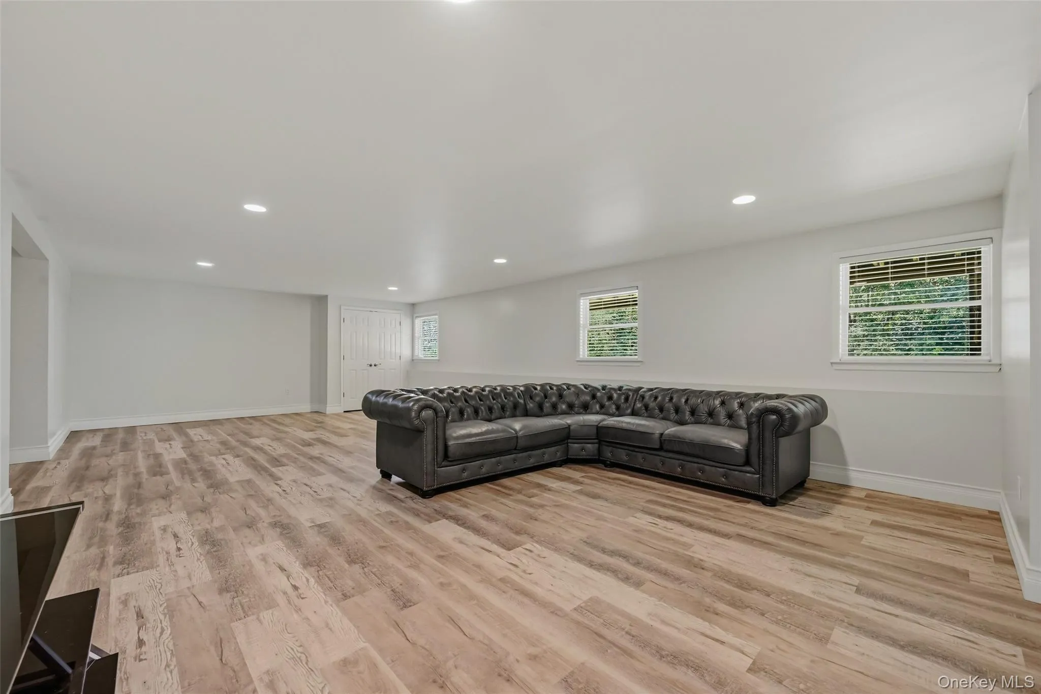 Spacious area featuring light wood-finish flooring and recessed lighting Spacious area featuring light wood-finish flooring and recessed lighting