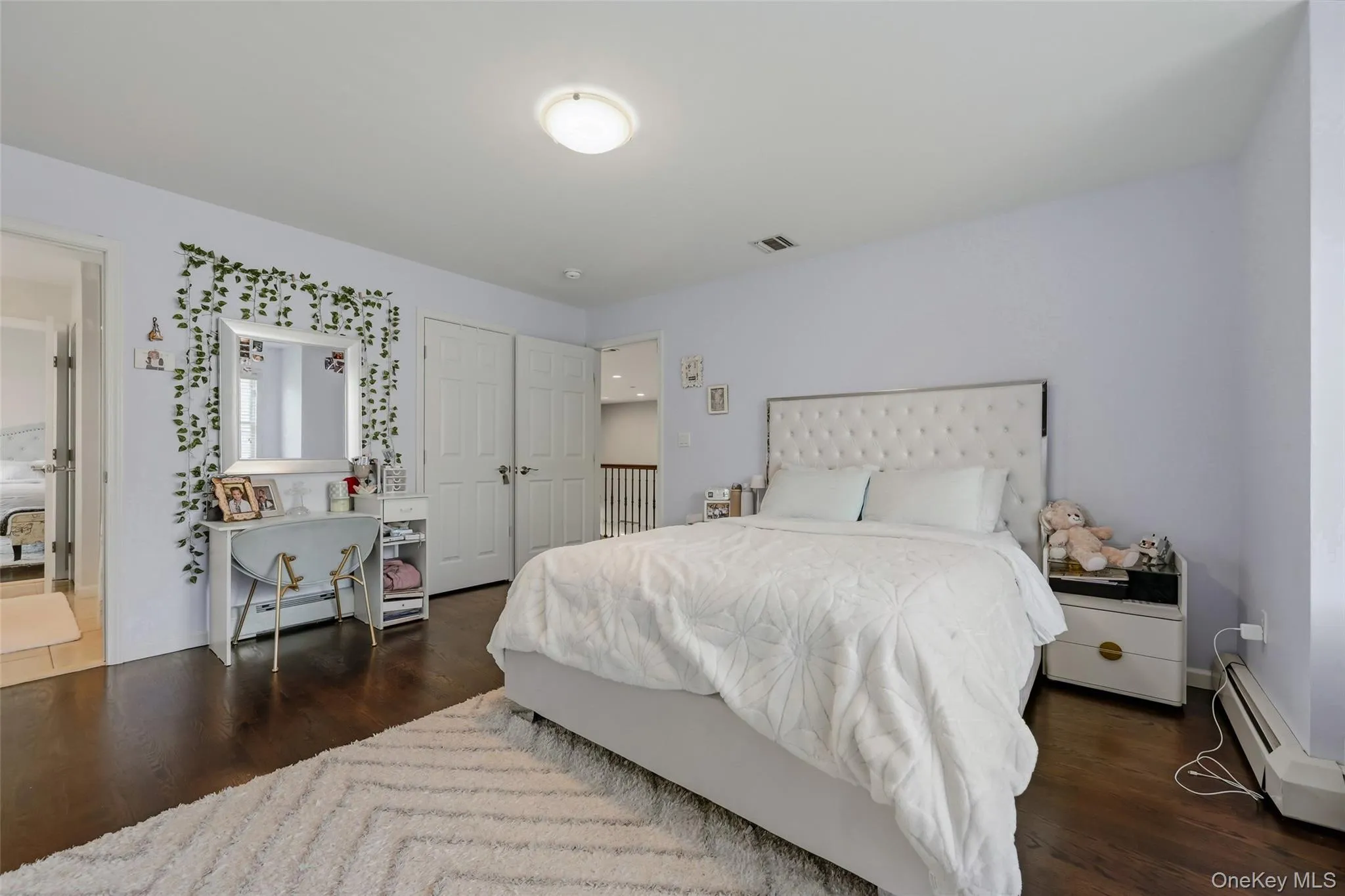 Spacious room featuring dark wood-finish flooring and light walls Spacious room featuring dark wood-finish flooring and light walls
