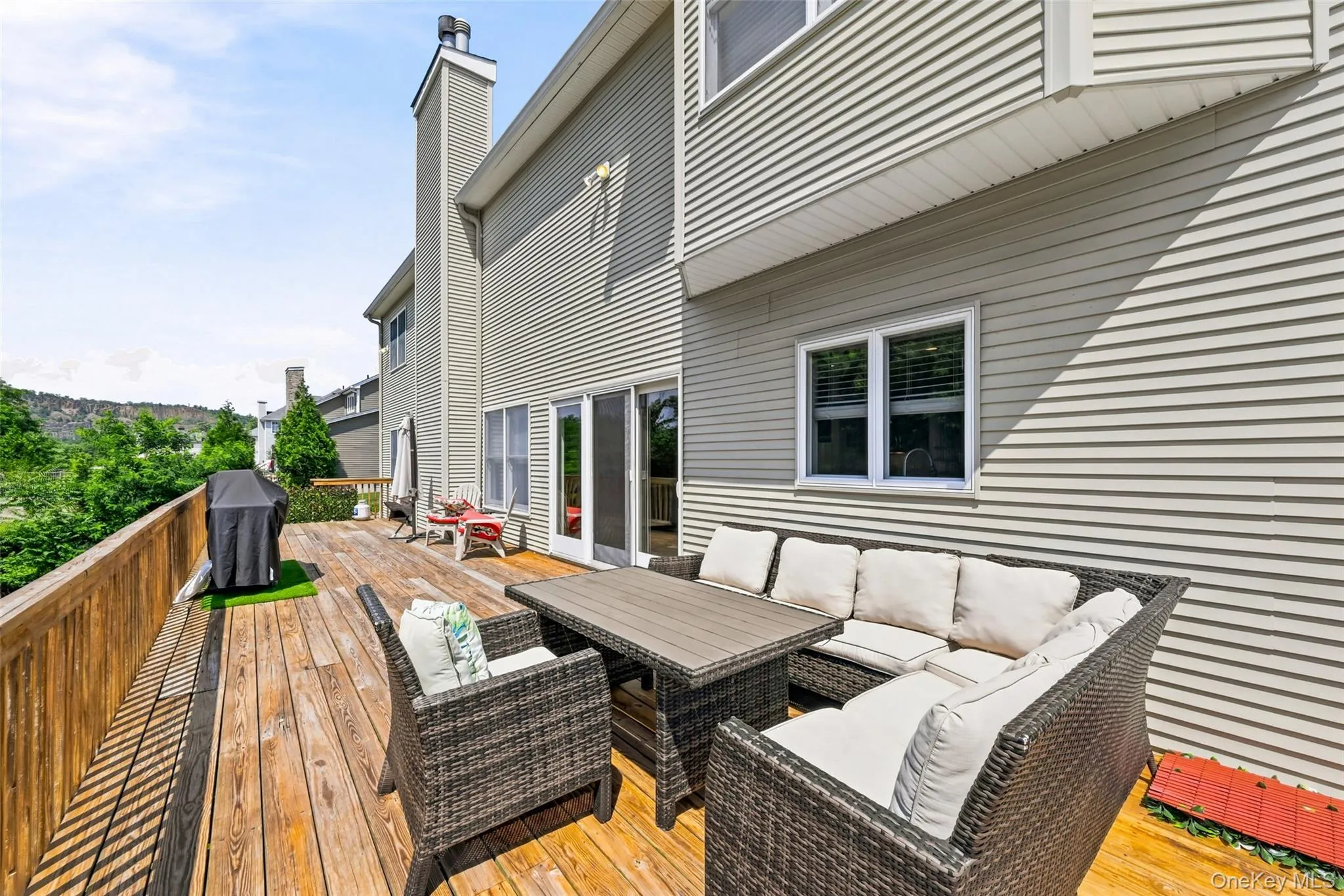 Expansive wood-finish deck with a wood-plank railing Expansive wood-finish deck with a wood-plank railing