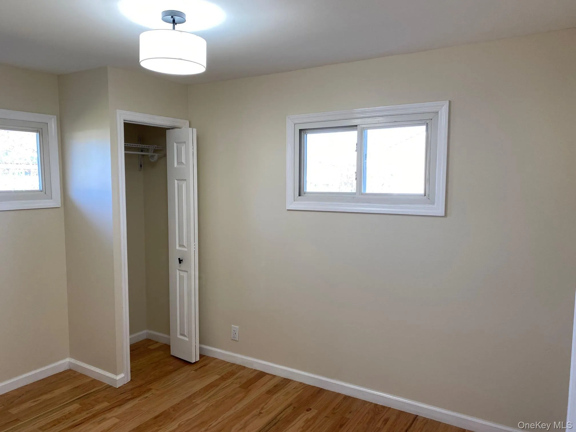 Bedroom 3 - Unfurnished bedroom with a closet, light wood-type flooring, and multiple windows Bedroom 3 - Unfurnished bedroom with a closet, light wood-type flooring, and multiple windows