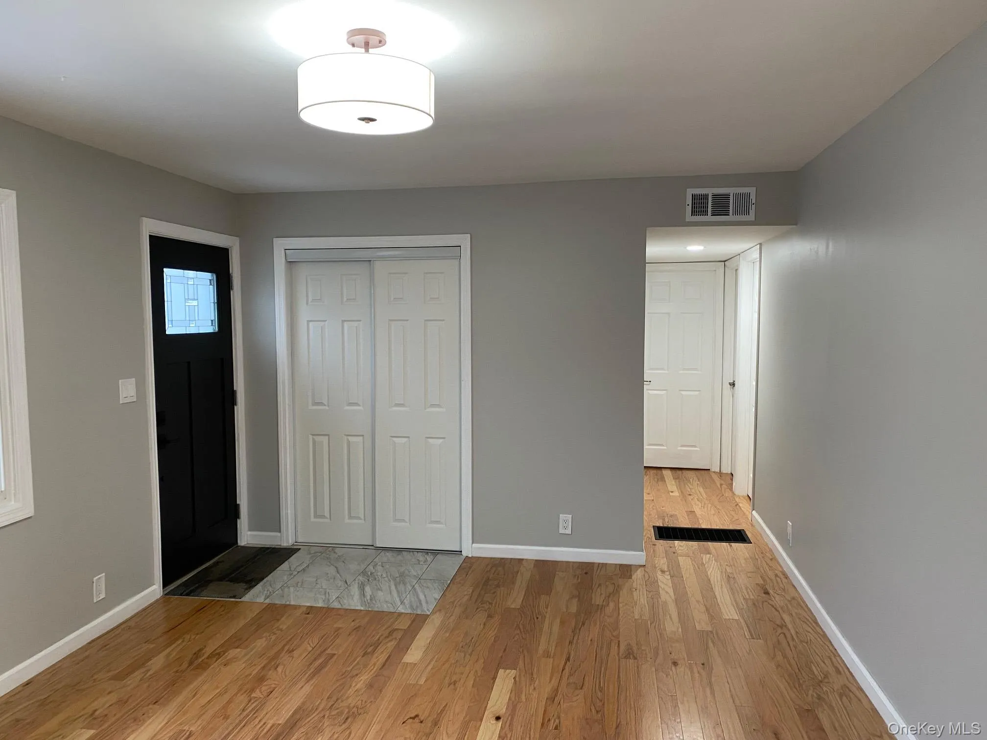 Foyer entrance with light wood-type flooring and baseboards Foyer entrance with light wood-type flooring and baseboards