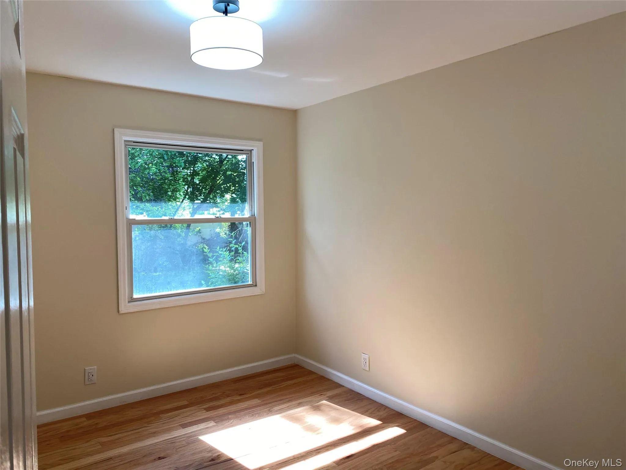 Bedroom 1 - featuring light wood finished floors and baseboards Bedroom 1 - featuring light wood finished floors and baseboards