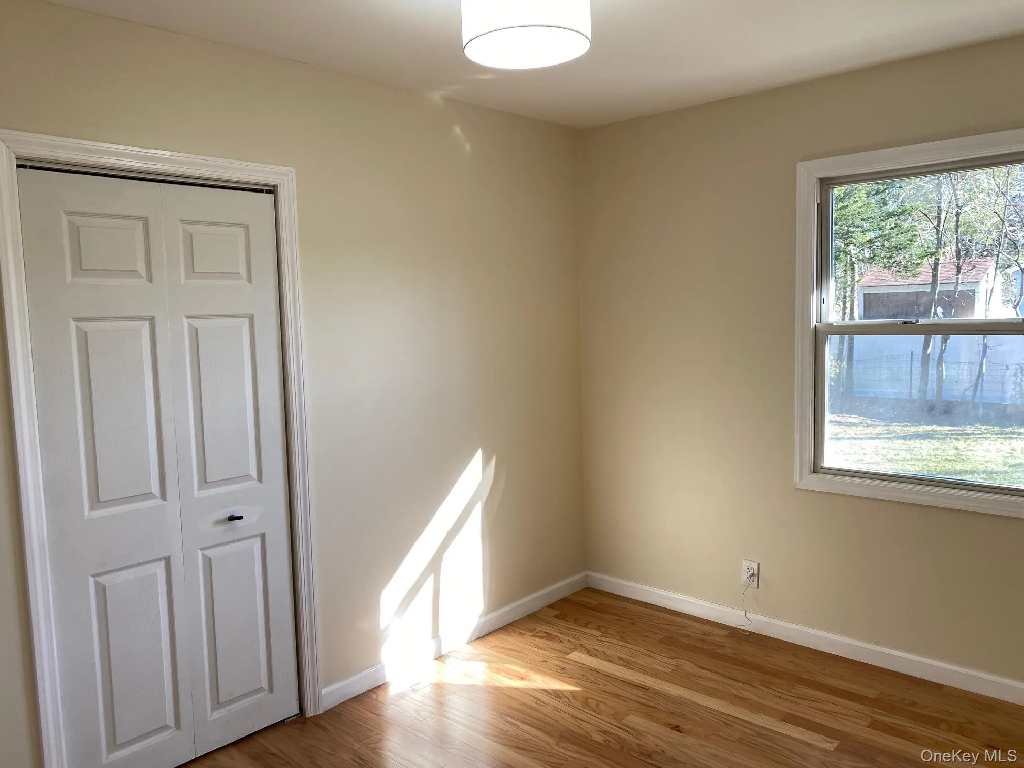 Bedroom1 - featuring harwood floors and ceiling light Bedroom1 - featuring harwood floors and ceiling light