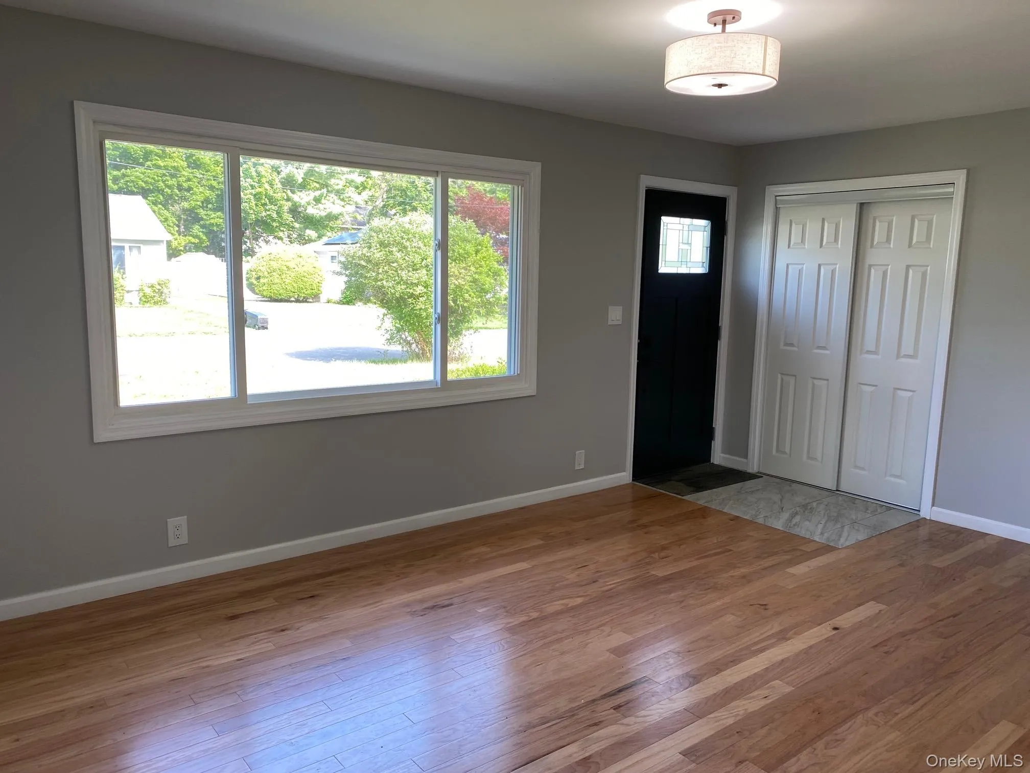 Entrance foyer featuring light wood-type flooring and baseboards Entrance foyer featuring light wood-type flooring and baseboards