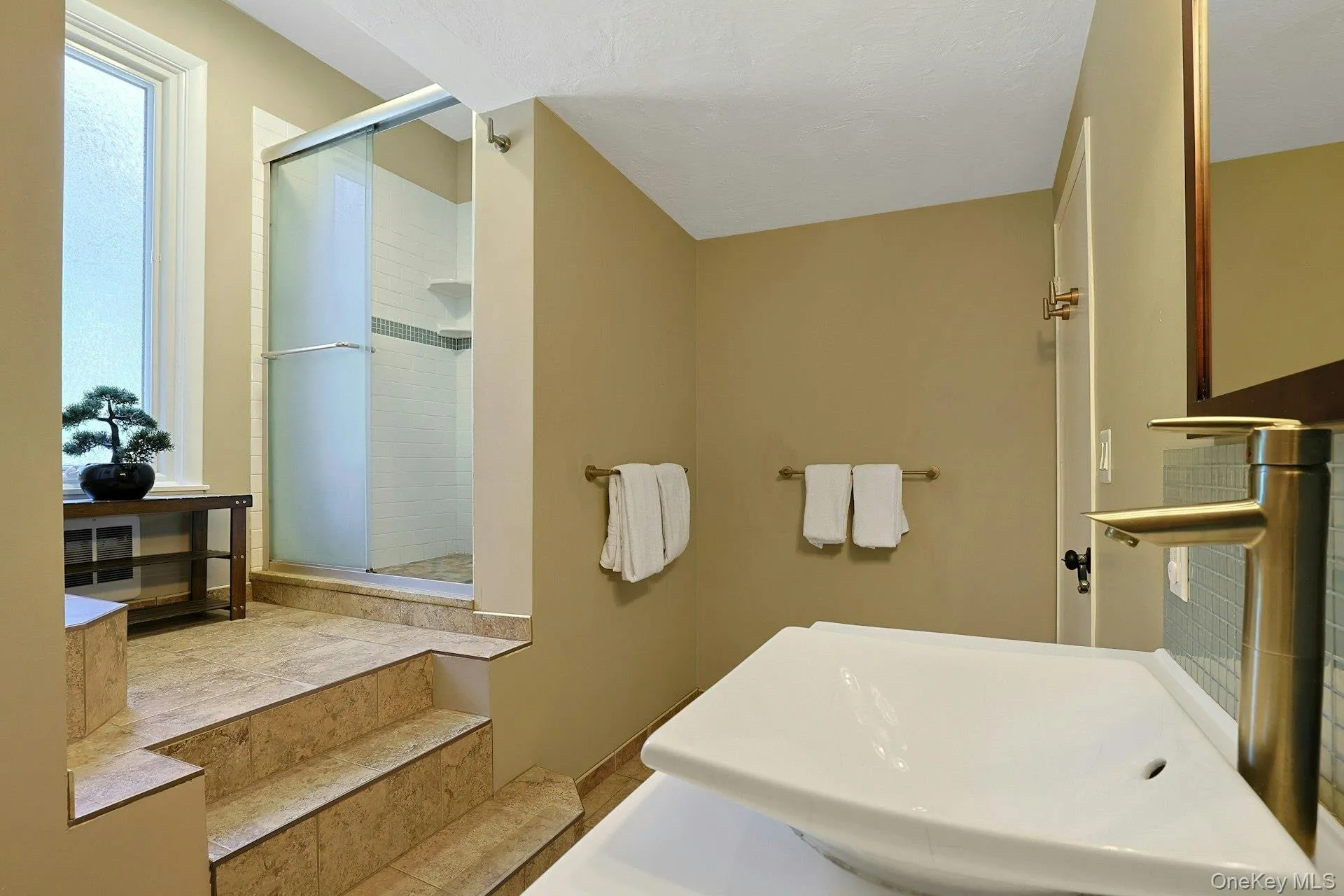 The full hall bathroom has, like so much of the rest of the home, been, thoroughly renovated. Across from the tile shower is a deep linen closet. The full hall bathroom has, like so much of the rest of the home, been, thoroughly renovated. Across from the tile shower is a deep linen closet.