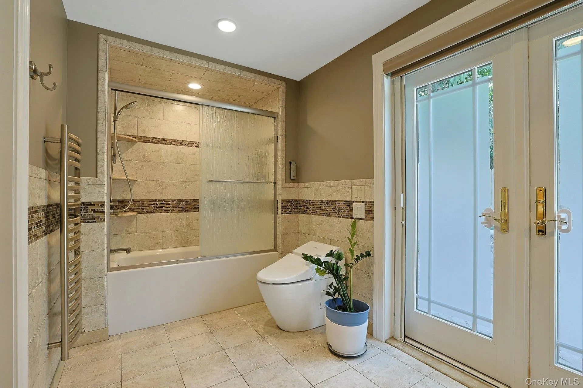 Beautifully tiled, the spa-like bathroom also has a tub with glass enclosure. Beautifully tiled, the spa-like bathroom also has a tub with glass enclosure.