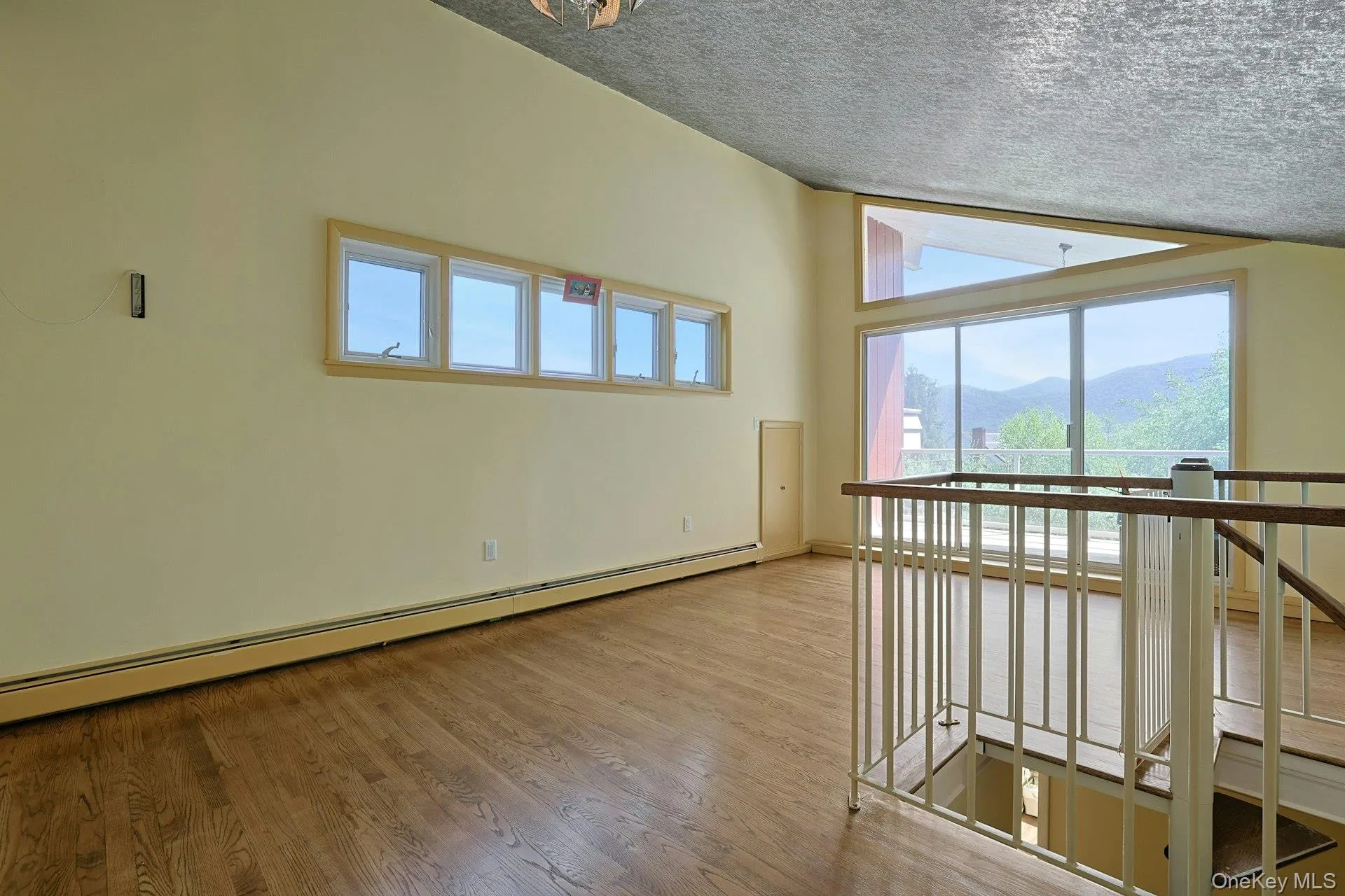 The expansive upper level loft has a high, vaulted ceiling and bonus eave-space storage. This large room would make great guest quarters, play space or family room. Sliding doors open to the balcony. The expansive upper level loft has a high, vaulted ceiling and bonus eave-space storage. This large room would make great guest quarters, play space or family room. Sliding doors open to the balcony.