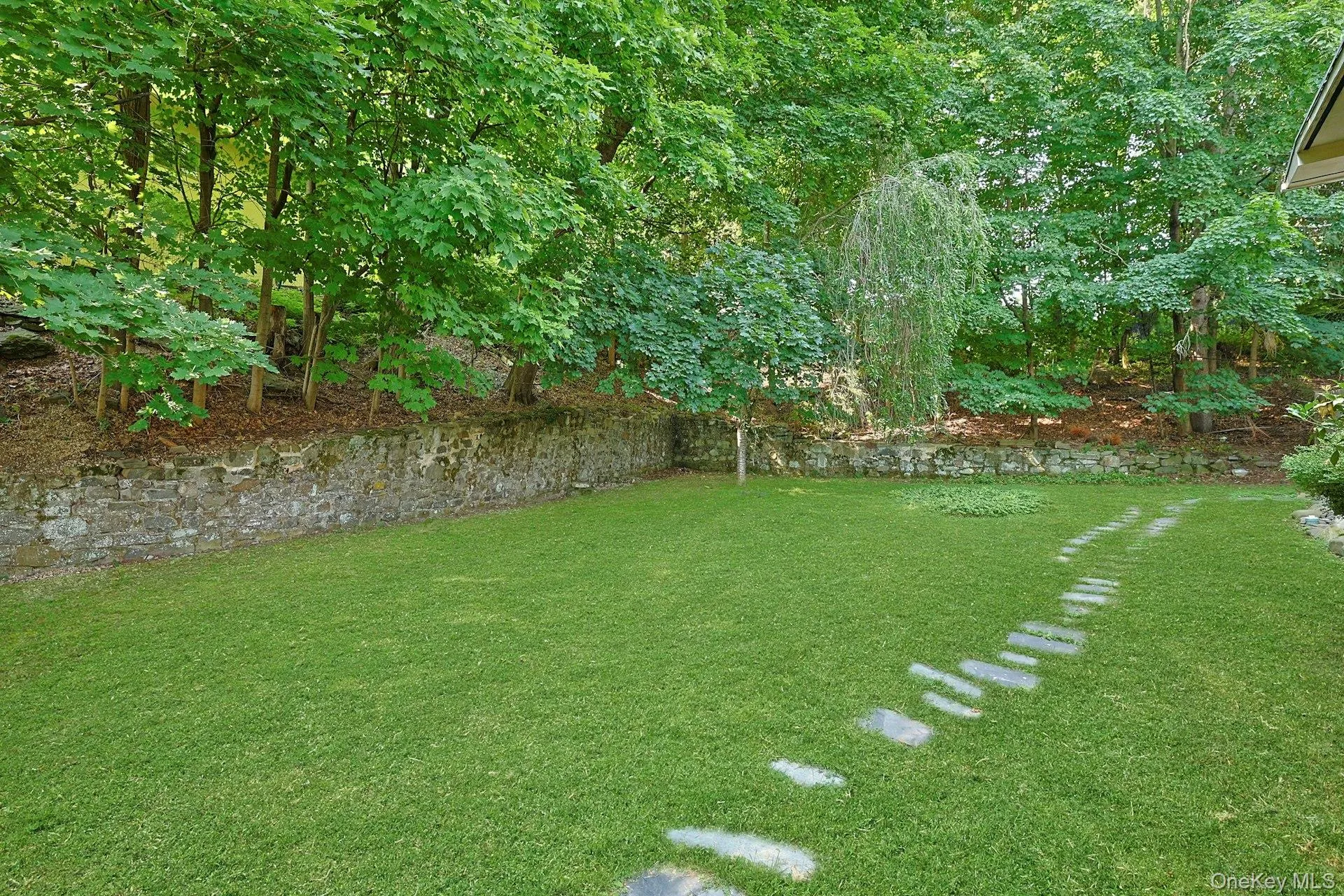 This stone path leads from the front of the home back to the pool. This stone path leads from the front of the home back to the pool.
