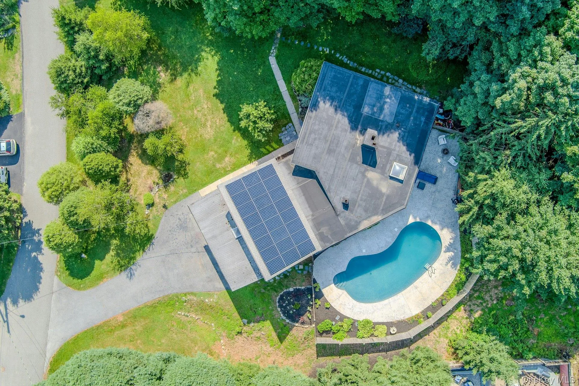 From above we can see the house, lawns and pool. From above we can see the house, lawns and pool.