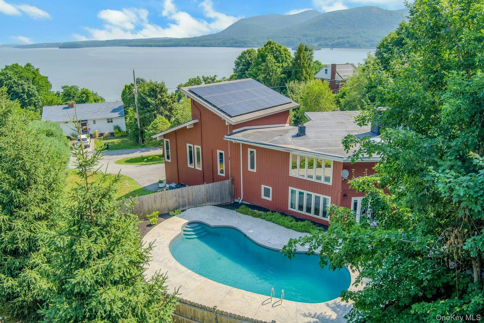 Perched atop a bluff on the Hudson River, this home has gorgeous views from many rooms, yet private areas around the beautiful backyard pool. Perched atop a bluff on the Hudson River, this home has gorgeous views from many rooms, yet private areas around the beautiful backyard pool.