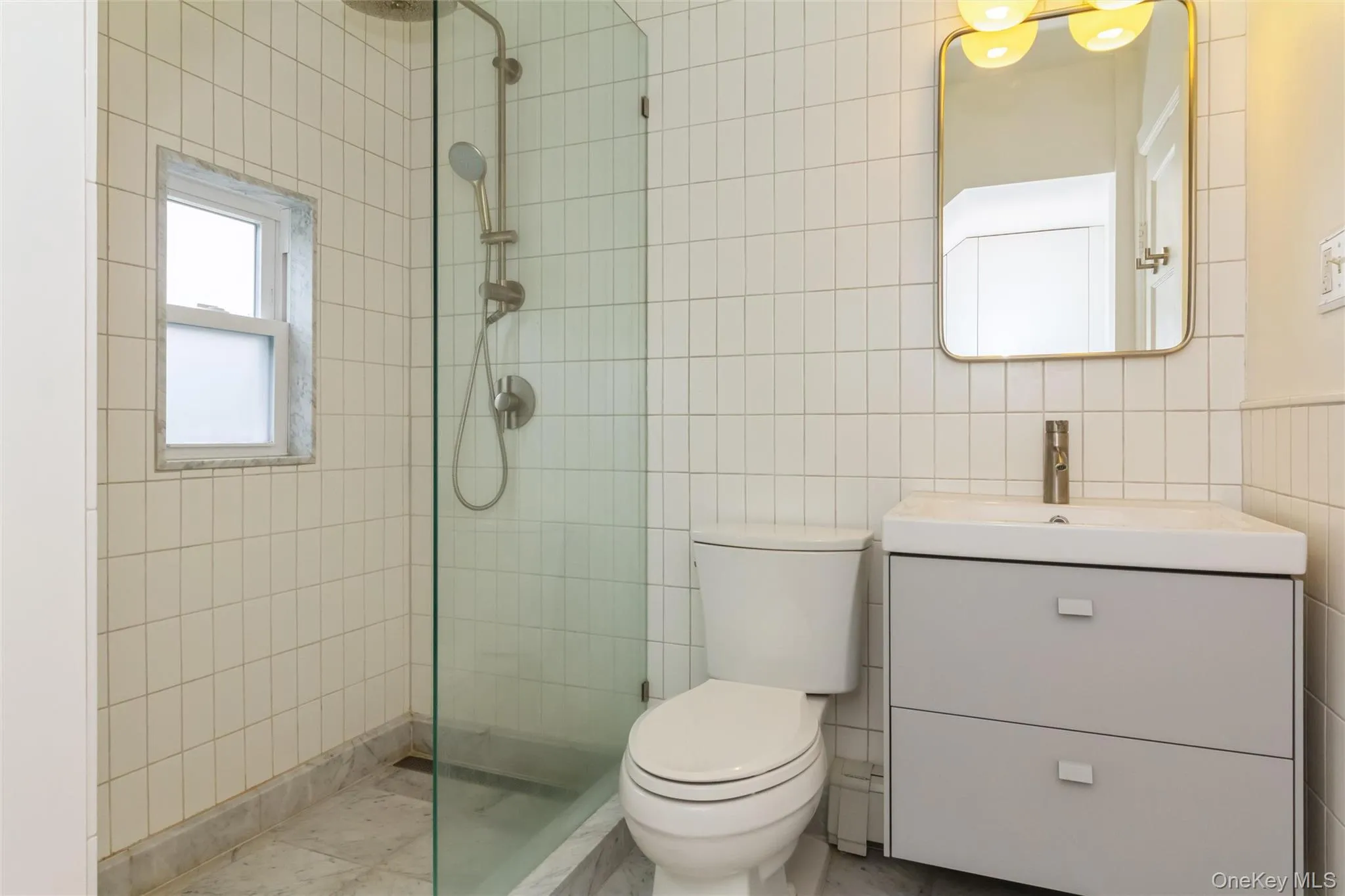 Shower with glass enclosure, rain shower head, and handheld sprayer Shower with glass enclosure, rain shower head, and handheld sprayer