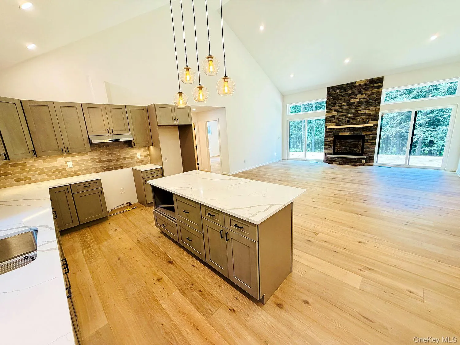 From kitchen looking into dining/living area. Gorgeous floors! LP gas fireplace, sliders to deck and back yard. From kitchen looking into dining/living area. Gorgeous floors! LP gas fireplace, sliders to deck and back yard.
