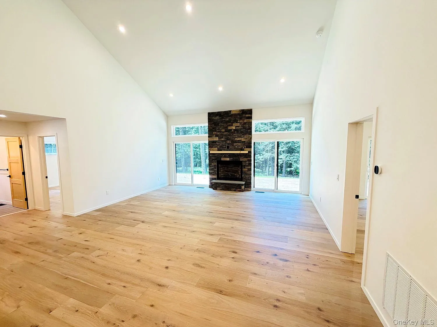 Gorgeous floors, Full glass wall looking outside, stone fireplace Gorgeous floors, Full glass wall looking outside, stone fireplace