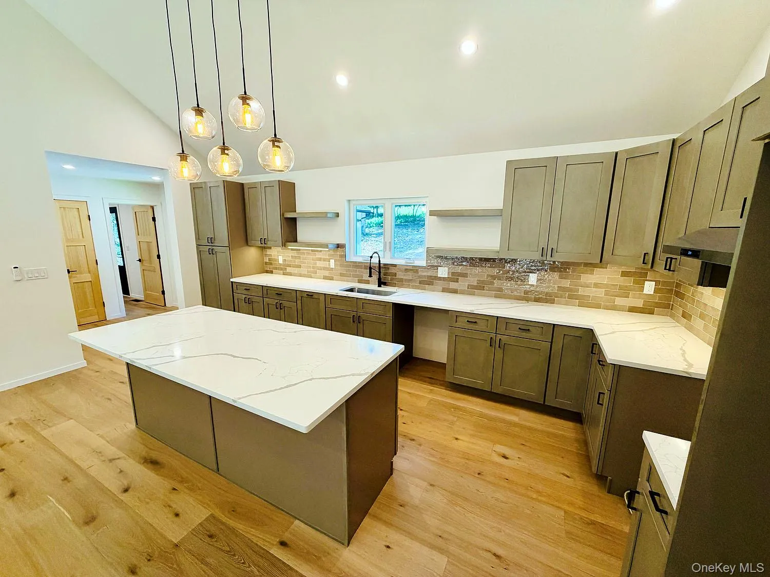 Beautiful pendant lighting, gleaming quartz countertops, spacious kitchen Beautiful pendant lighting, gleaming quartz countertops, spacious kitchen