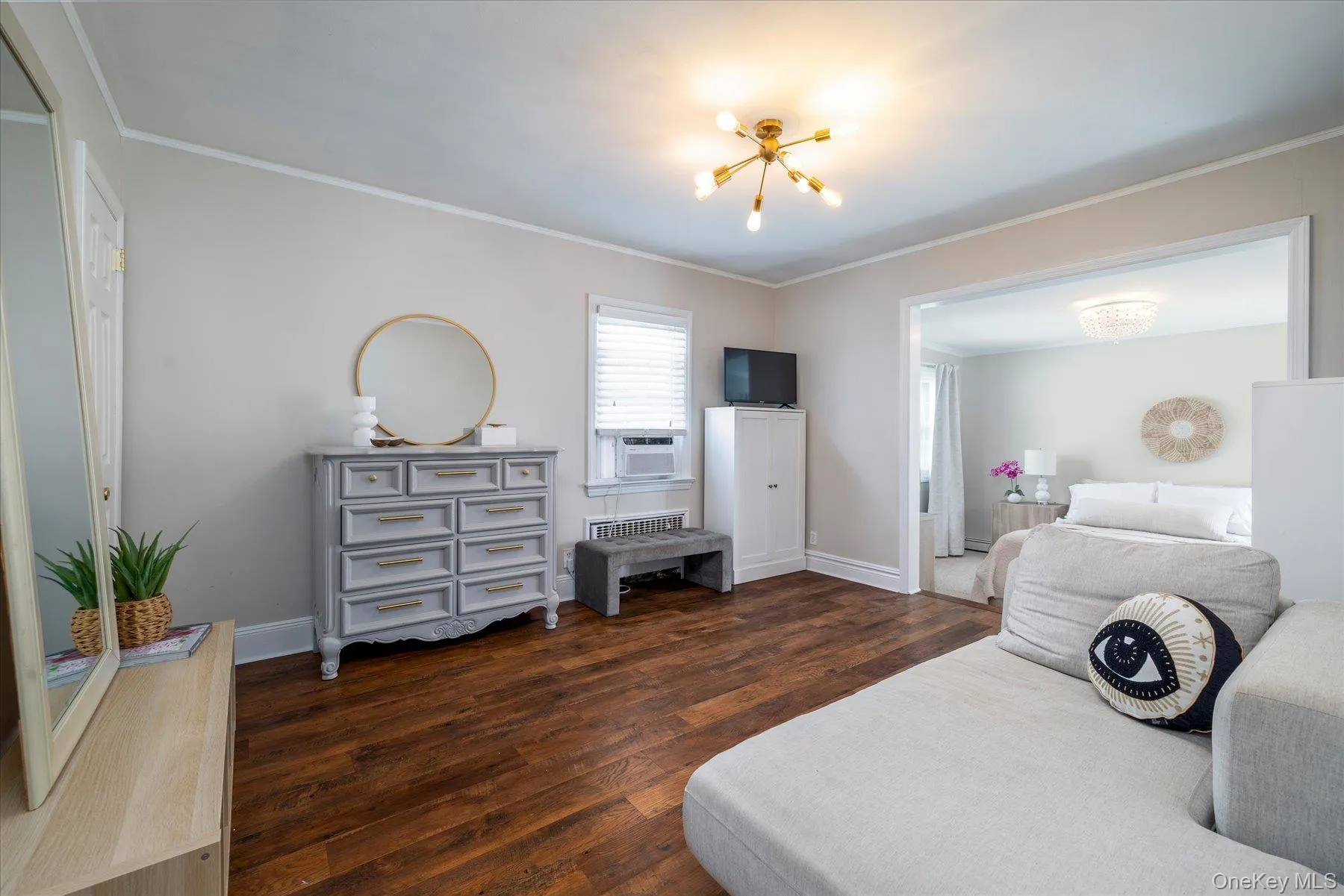 Hardwood-finish flooring dressing room extending into primary bedroom Hardwood-finish flooring dressing room extending into primary bedroom
