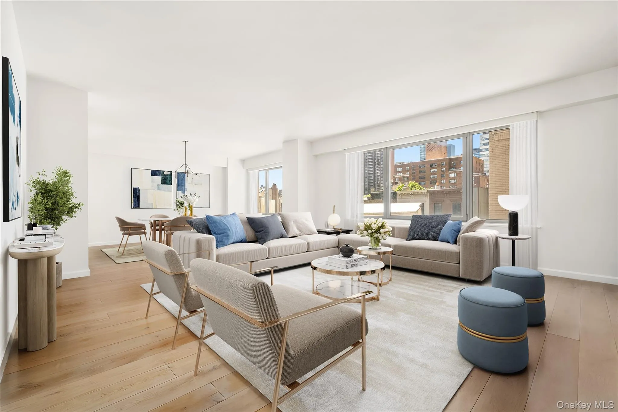 Spacious living area featuring light wood-finish flooring, recessed lighting, and a large window Spacious living area featuring light wood-finish flooring, recessed lighting, and a large window