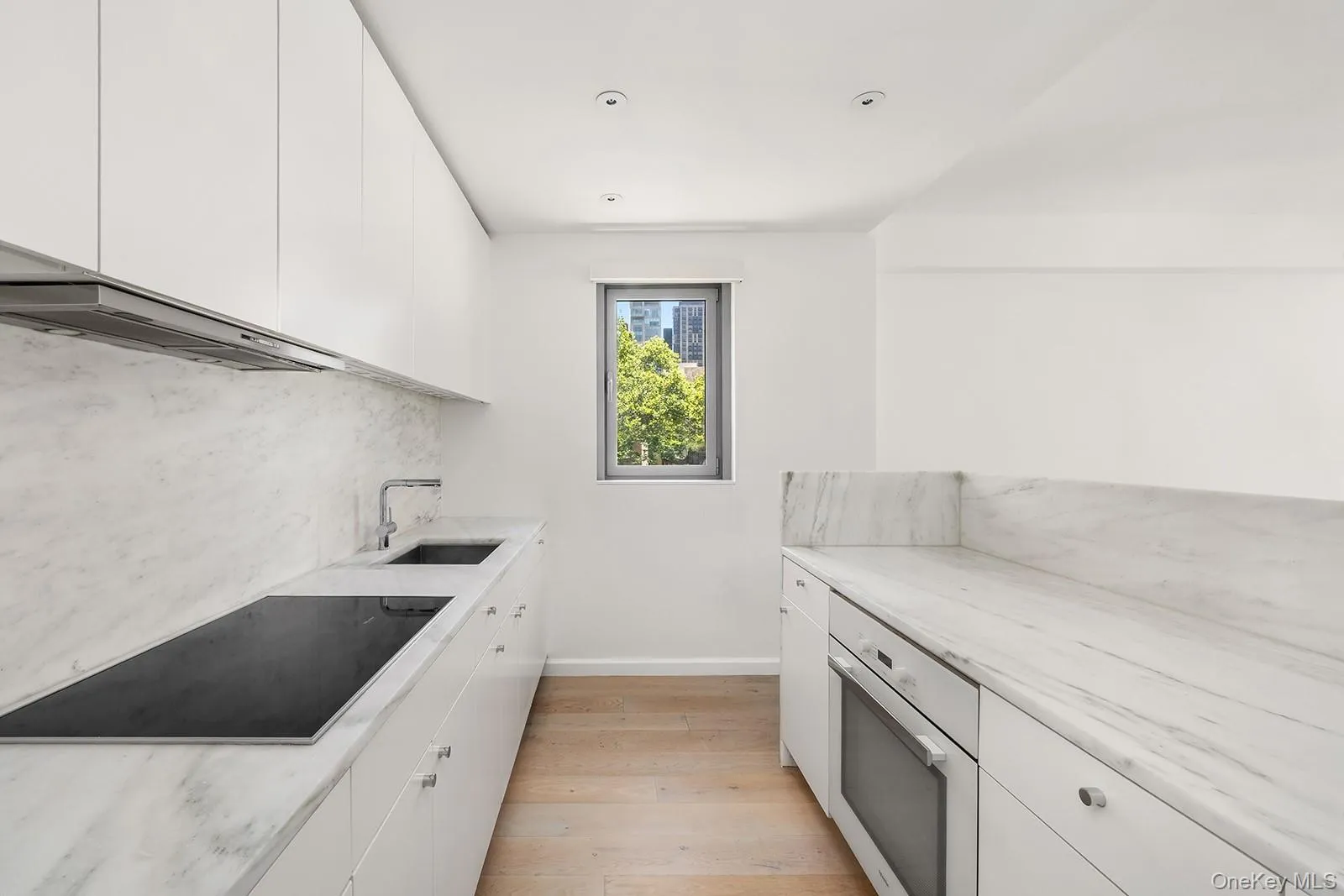 Contemporary kitchen featuring light wood-finish flooring and recessed lighting Contemporary kitchen featuring light wood-finish flooring and recessed lighting