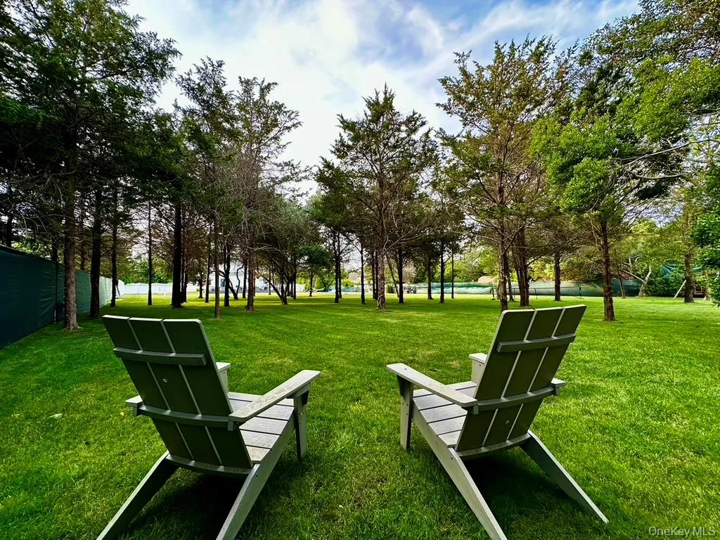 Large, leveled, and fenced backyard with mature trees offering shade and plenty space for play. Large, leveled, and fenced backyard with mature trees offering shade and plenty space for play.