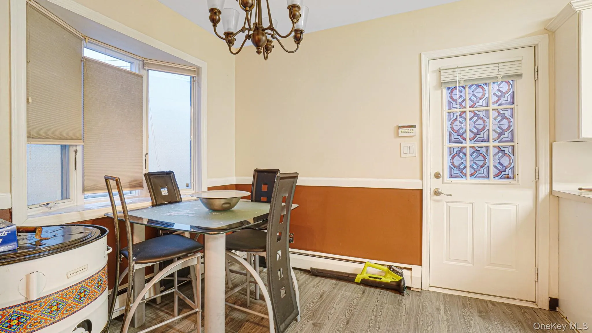 Dining space featuring an inviting chandelier, wood finished floors, and plenty of natural light Dining space featuring an inviting chandelier, wood finished floors, and plenty of natural light
