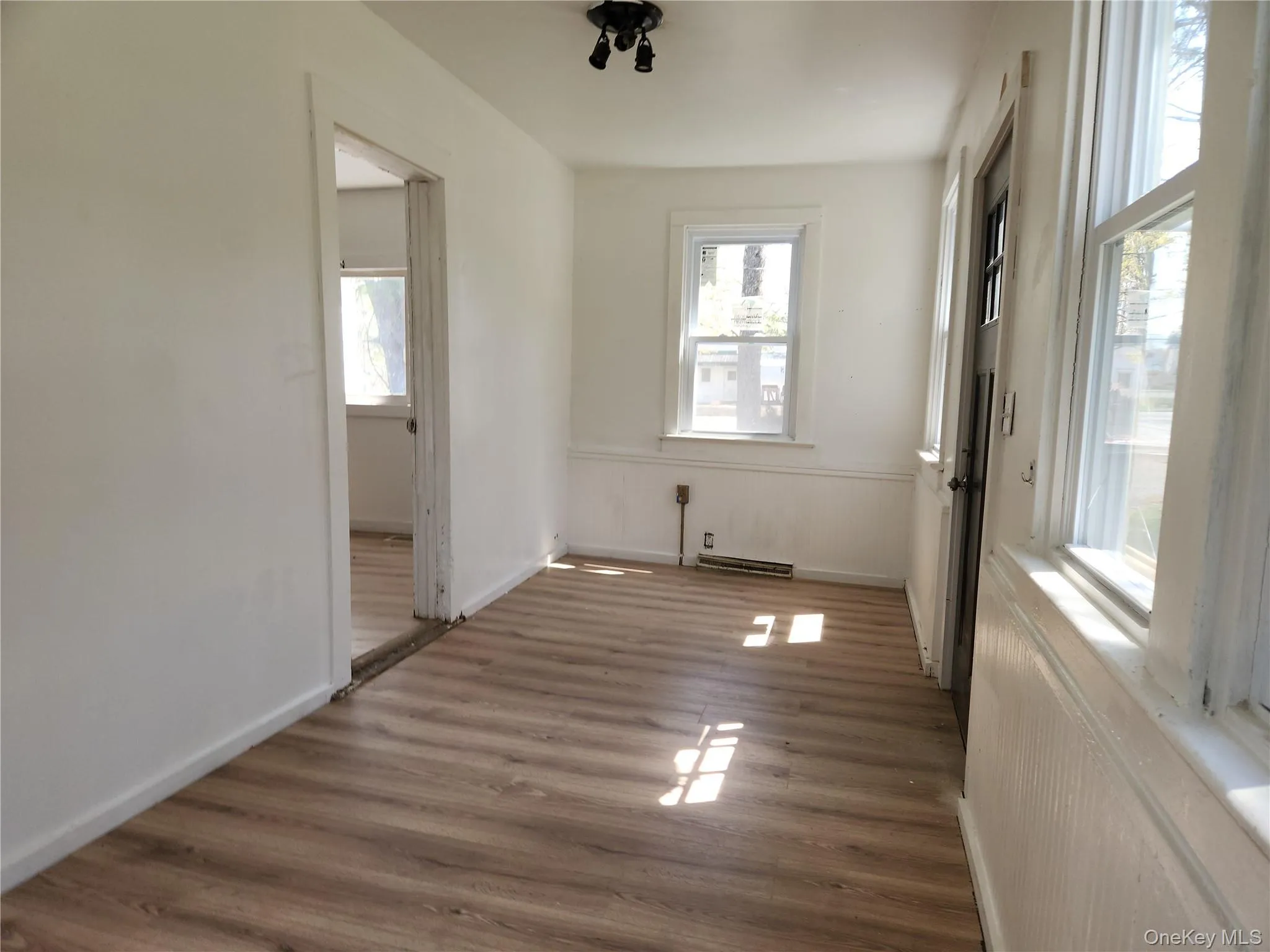 Could be Sunroom or office, laminate wood finished floors, and a wealth of natural light Could be Sunroom or office, laminate wood finished floors, and a wealth of natural light