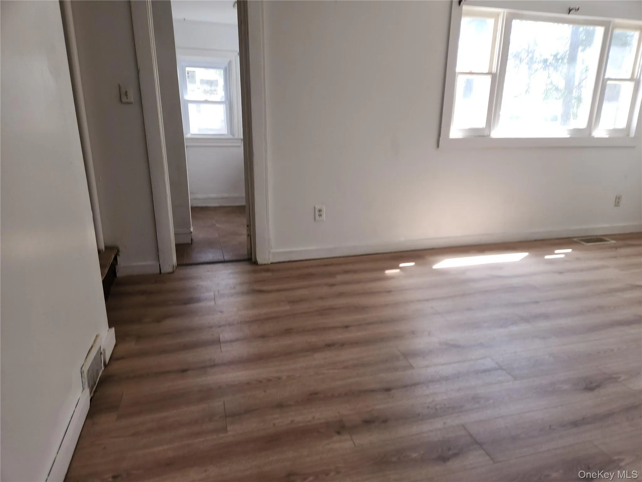 Living room featuring laminate wood finished floors Living room featuring laminate wood finished floors