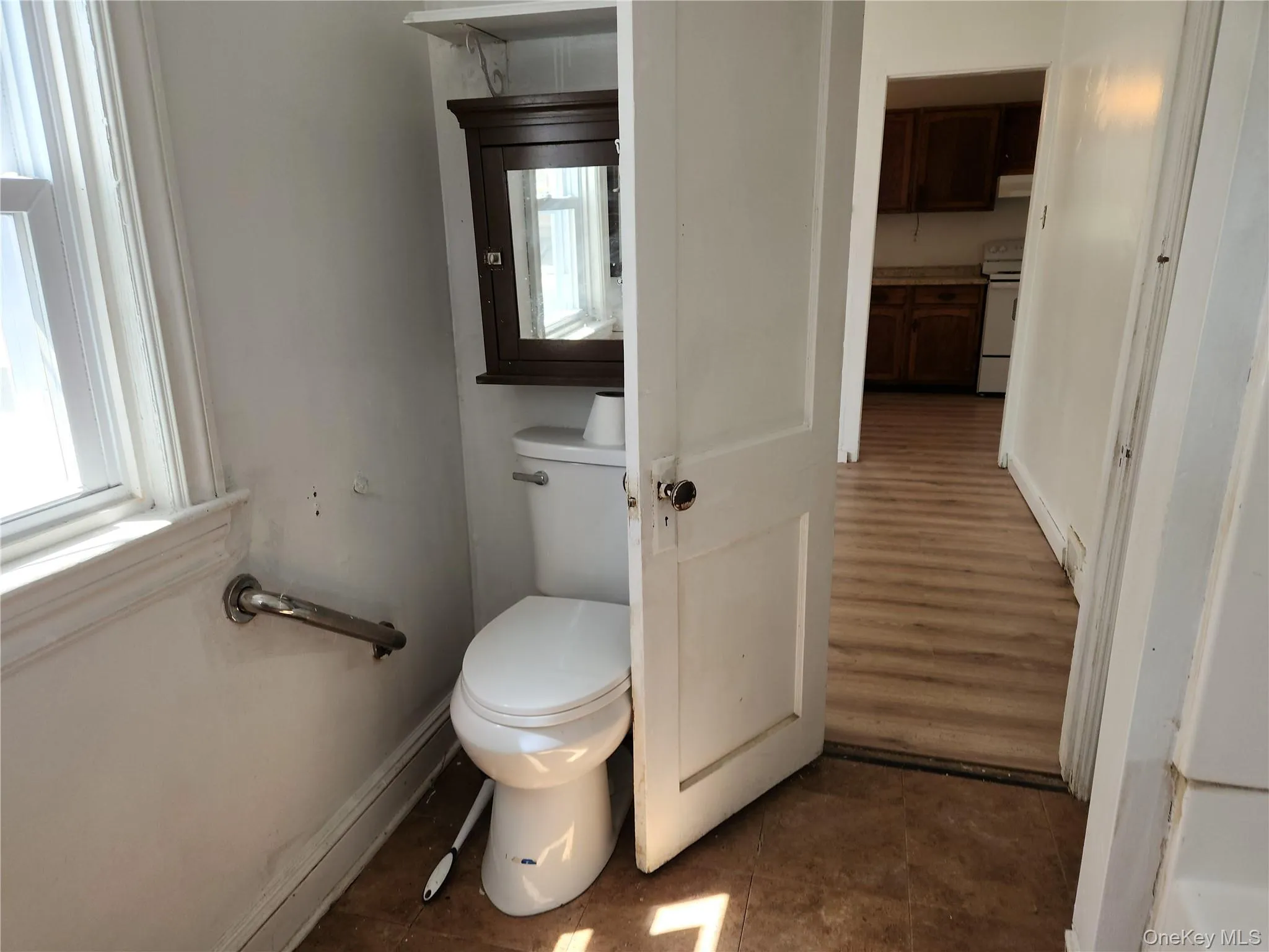 Bathroom featuring tile patterned floors, and toilet Bathroom featuring tile patterned floors, and toilet
